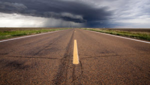 A severe thunderstorm passes over the highway in western Kansas